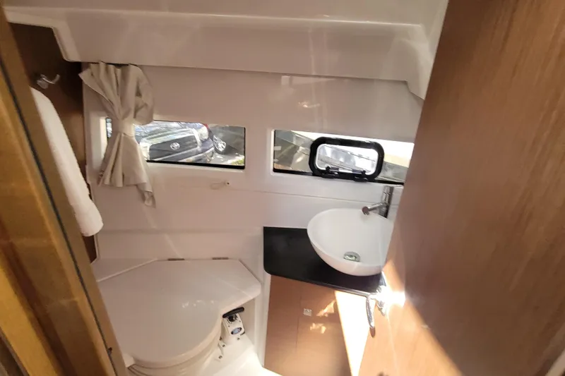 Slide: The Image of 2023 Jeanneau NC 895 boat bathroom with sink, toilet, and window. - 21