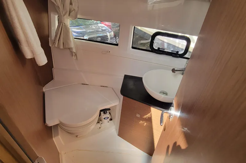 Slide: The Image of 2023 Jeanneau NC 895 boat bathroom with sink, toilet, and window. - 23