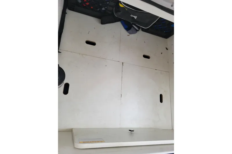 Slide: The Image of Storage compartment of 2023 Jeanneau NC 895 boat, featuring organized interior space. - 28