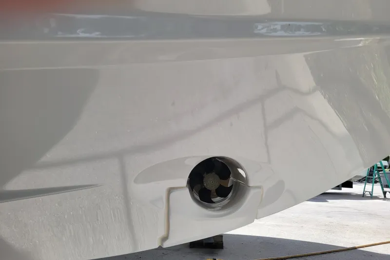 Slide: The Image of 2023 Jeanneau NC 895 boat hull with visible thruster detail. - 31