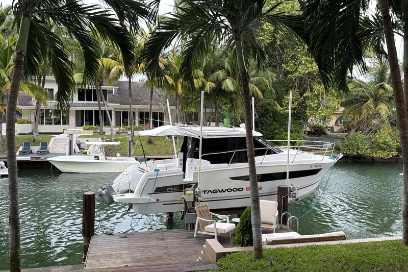 Slide: The Image of 2023 Jeanneau NC 895 docked by a tropical waterfront home. - 32