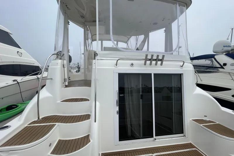 Slide: The Image of 2006 Meridian 459 Motoryacht with sleek design, featuring steps and sliding glass doors. - 12