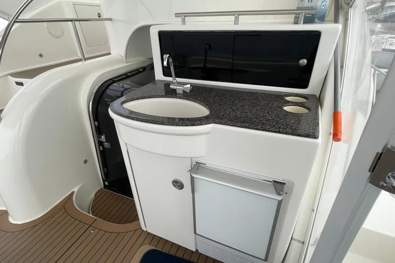 Slide: The Image of 2006 Meridian 459 Motoryacht kitchenette with sink, countertop, and storage. - 15