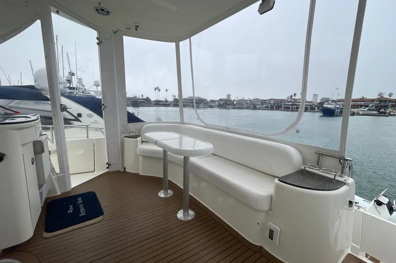 Slide: The Image of 2006 Meridian 459 Motoryacht interior with seating and table, overlooking marina. - 16