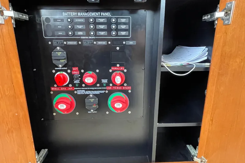Slide: The Image of Battery management panel in a 2006 Meridian 459 Motoryacht, with control switches and storage shelf. - 21