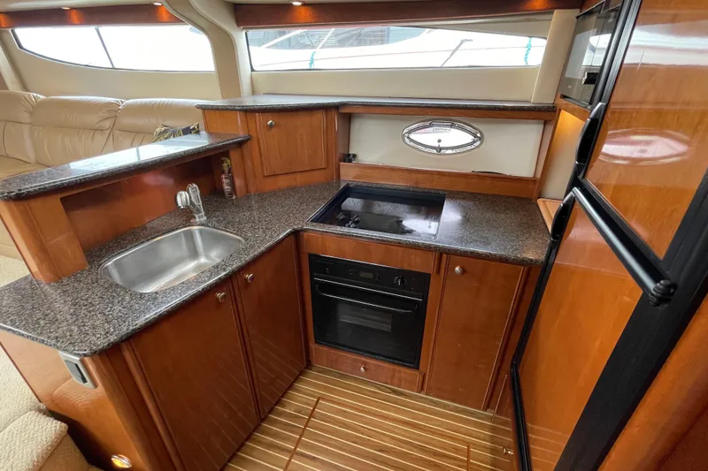Slide: The Image of Luxurious kitchen in 2006 Meridian 459 Motoryacht with granite countertops and modern appliances. - 28