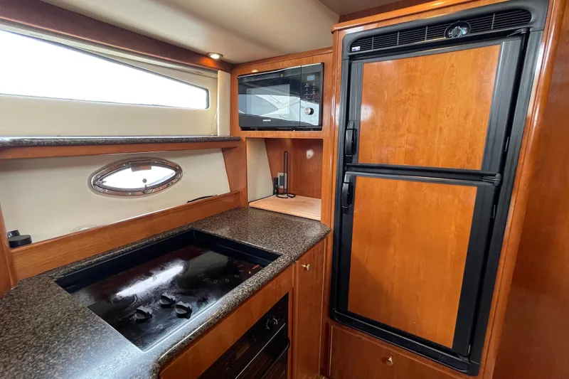 Slide: The Image of Luxurious kitchen interior of 2006 Meridian 459 Motoryacht with modern appliances and wood finish. - 30