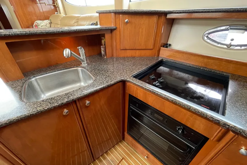 Slide: The Image of 2006 Meridian 459 Motoryacht kitchen with granite countertops, sink, and stove. - 31