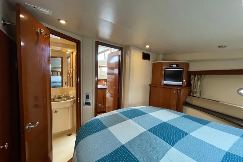 Slide: The Image of 2006 Meridian 459 Motoryacht interior with bedroom, bathroom, and TV cabinet. - 36
