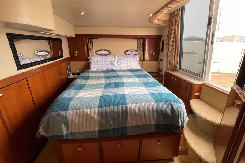Slide: The Image of Luxurious bedroom interior of 2006 Meridian 459 Motoryacht with cozy bed and elegant wood finishes. - 39