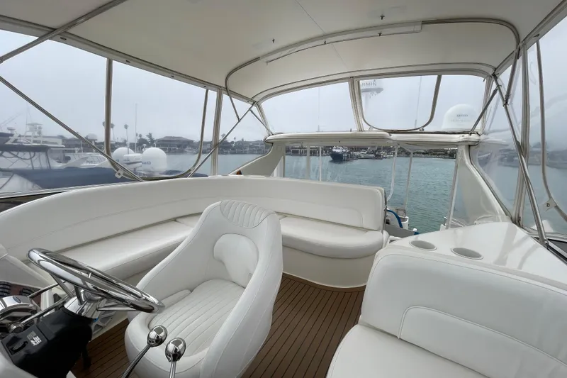 Slide: The Image of Luxurious 2006 Meridian 459 Motoryacht interior with white seating and wooden flooring. - 49