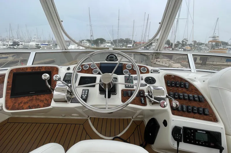 Slide: The Image of Helm of 2006 Meridian 459 Motoryacht with modern navigation equipment and wood accents. - 51
