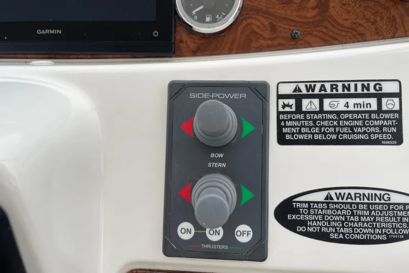 Slide: The Image of Control panel of 2006 Meridian 459 Motoryacht with warning labels and thruster controls. - 53