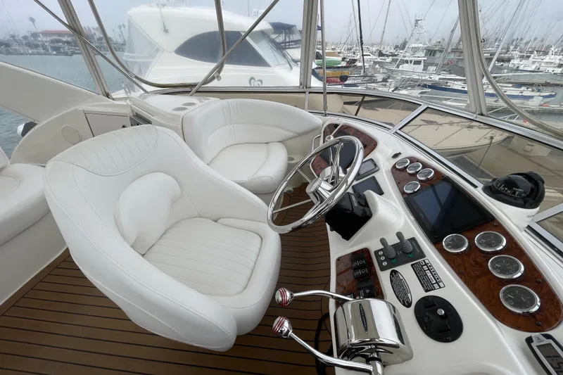 Slide: The Image of 2006 Meridian 459 Motoryacht helm with white leather seats and modern controls. - 54