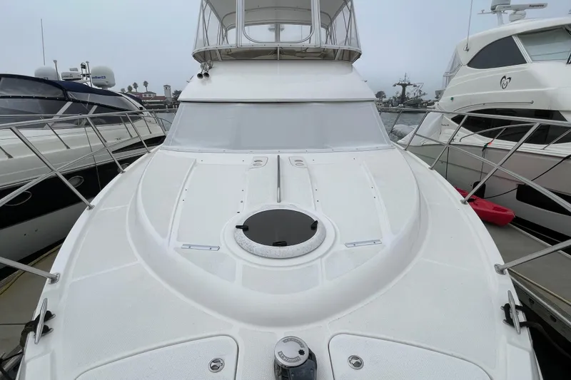 Slide: The Image of 2006 Meridian 459 Motoryacht docked, showcasing sleek design and spacious deck. - 57