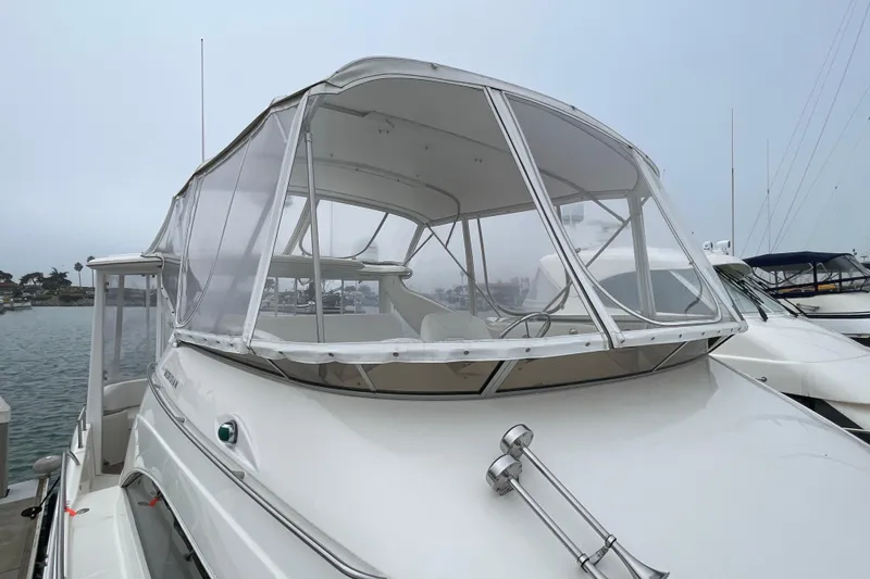 Slide: The Image of 2006 Meridian 459 Motoryacht docked, featuring enclosed flybridge and sleek design. - 58