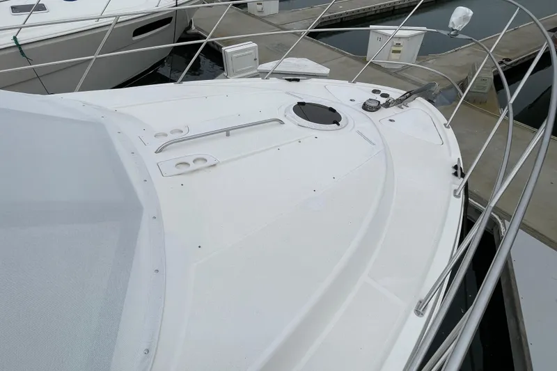 Slide: The Image of 2006 Meridian 459 Motoryacht bow view at marina, showcasing deck and railing. - 60