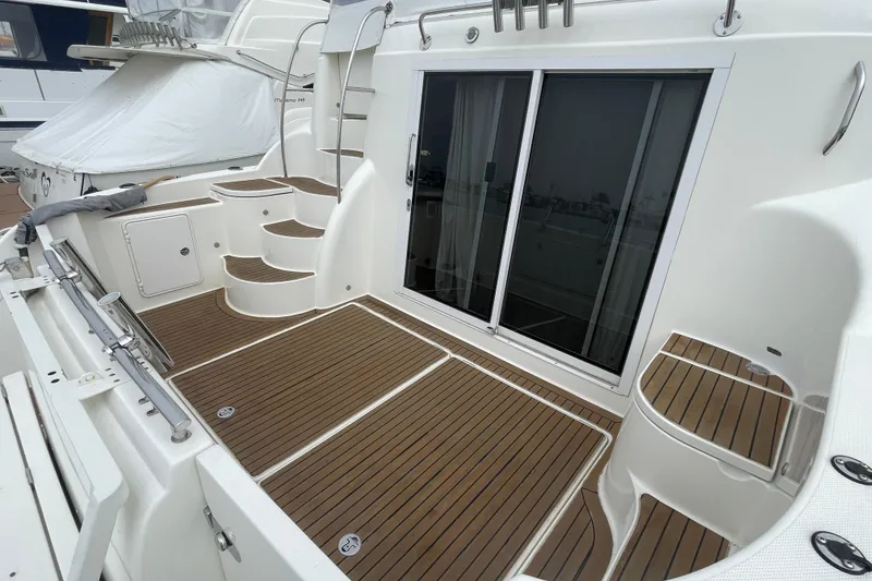 Slide: The Image of 2006 Meridian 459 Motoryacht deck with wooden flooring and sliding glass doors. - 7