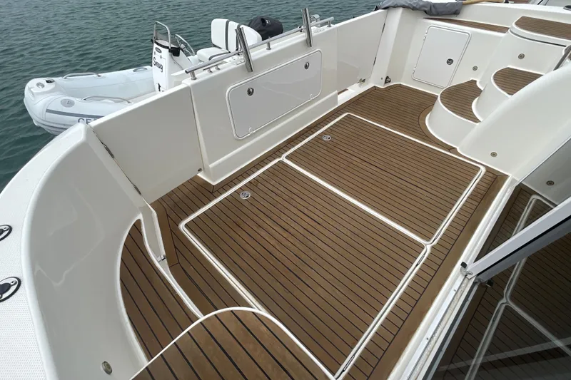 Slide: The Image of 2006 Meridian 459 Motoryacht deck with teak flooring and steps, docked near water. - 8