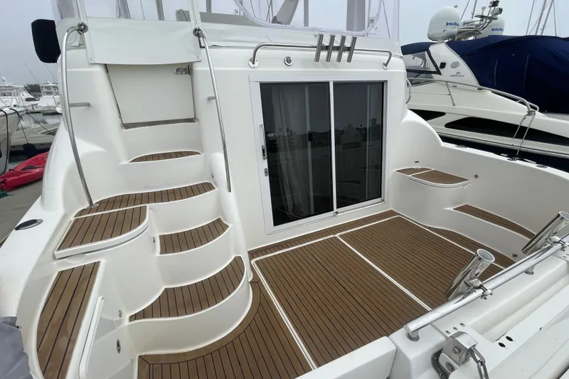 Slide: The Image of 2006 Meridian 459 Motoryacht deck with teak flooring and sliding glass doors. - 9