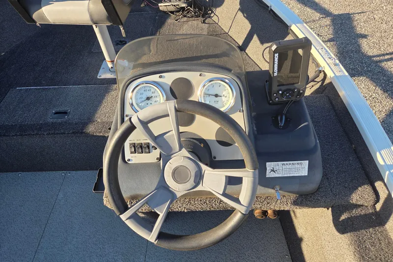 Slide: The Image of 2017 Lowe Fishing Machine 160 Pro dashboard with steering wheel and fish finder. - 11