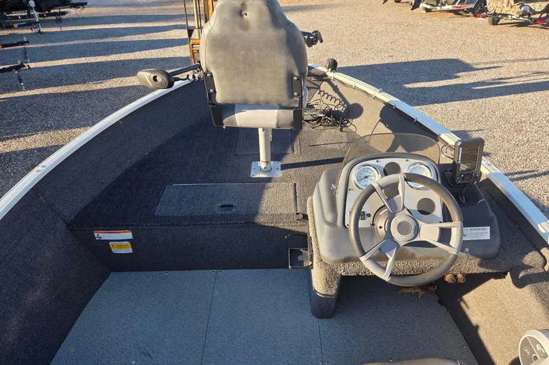 Slide: The Image of 2017 Lowe Fishing Machine 160 Pro boat interior with steering wheel and seat. - 12
