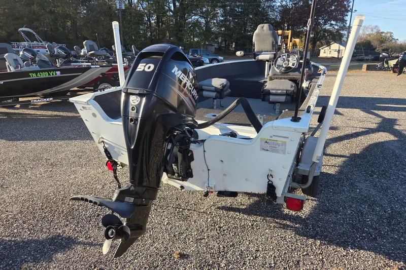 Slide: The Image of 2017 Lowe Fishing Machine 160 Pro with Mercury 50 outboard motor, parked on gravel. - 4