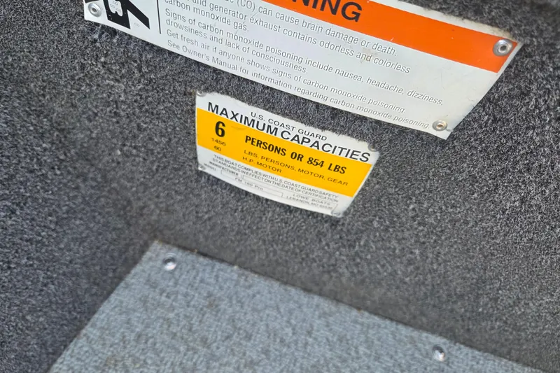 Slide: The Image of 2017 Lowe Fishing Machine 160 Pro capacity label, maximum 6 persons or 854 lbs. - 6