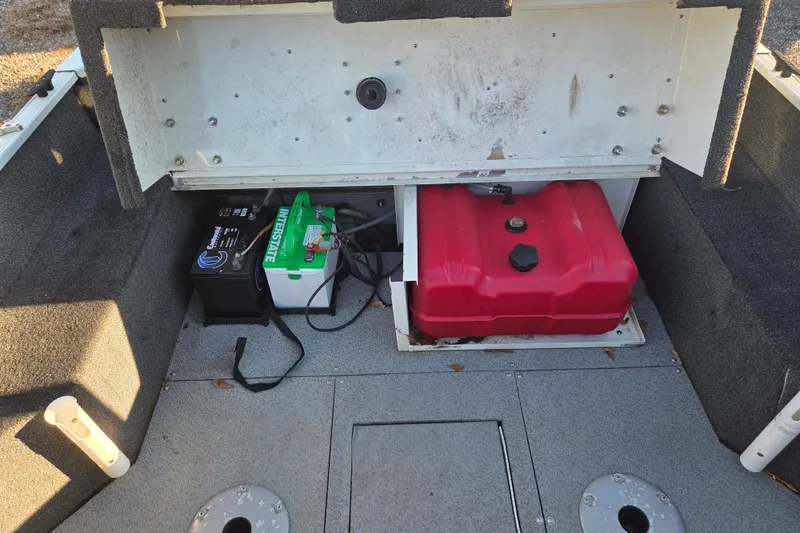 Slide: The Image of 2017 Lowe Fishing Machine 160 Pro boat interior with battery and fuel tank. - 7