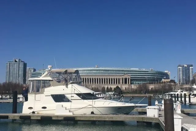 Slide: The Image of 1997 Silverton 352 Motor Yacht docked with city skyline and stadium in background. - 1