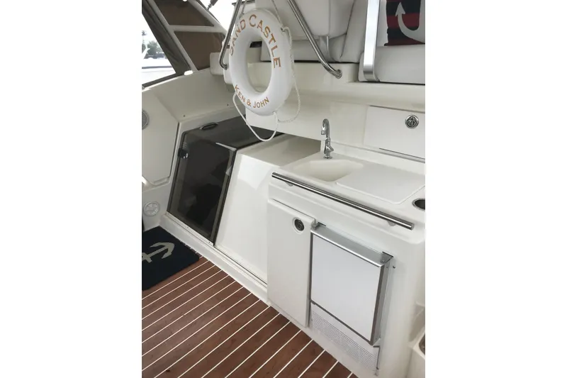 Slide: The Image of 1997 Silverton 352 Motor Yacht interior with sink, storage, and life preserver. - 14