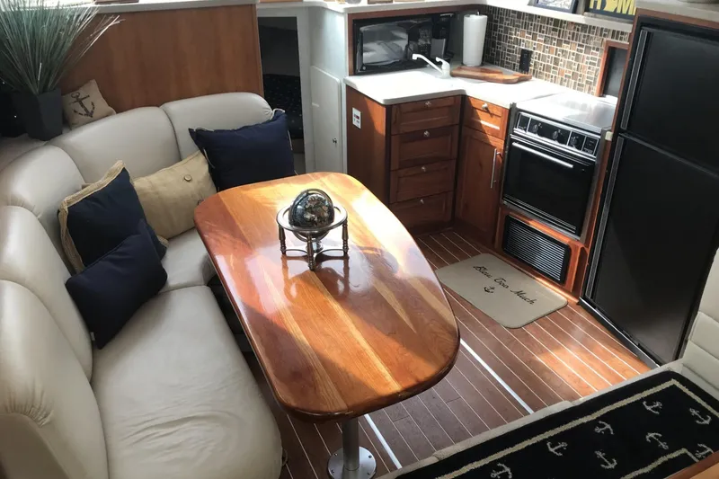 Slide: The Image of Luxurious 1997 Silverton 352 Motor Yacht interior with kitchen and dining area. - 17