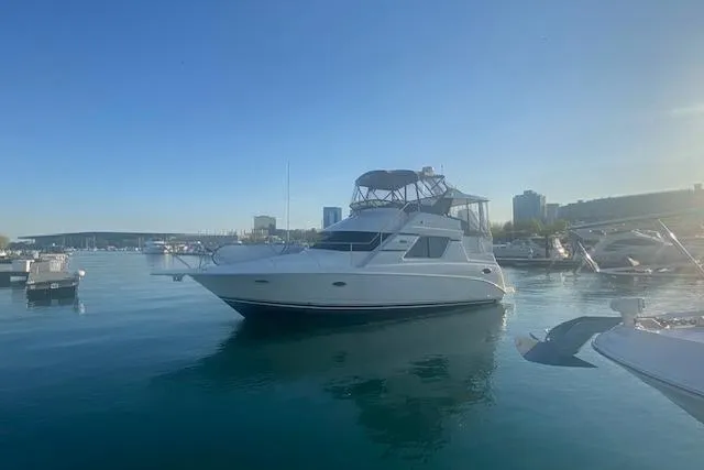 Slide: The Image of 1997 Silverton 352 Motor Yacht docked in a serene marina setting. - 2