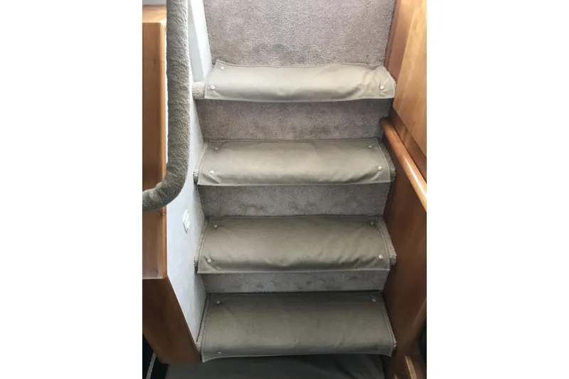 Slide: The Image of Carpeted stairs inside a 1997 Silverton 352 Motor Yacht. - 23