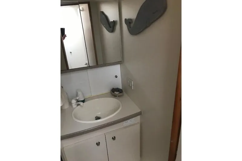 Slide: The Image of 1997 Silverton 352 Motor Yacht bathroom with sink and mirror. - 24