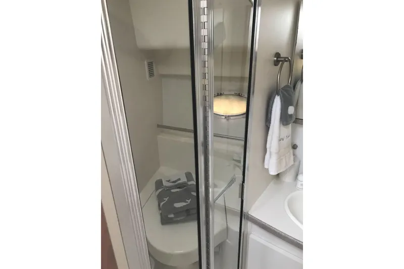 Slide: The Image of Bathroom interior of 1997 Silverton 352 Motor Yacht with shower and towels. - 25