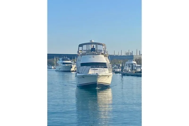 Slide: The Image of 1997 Silverton 352 Motor Yacht docked in a marina under clear blue skies. - 4