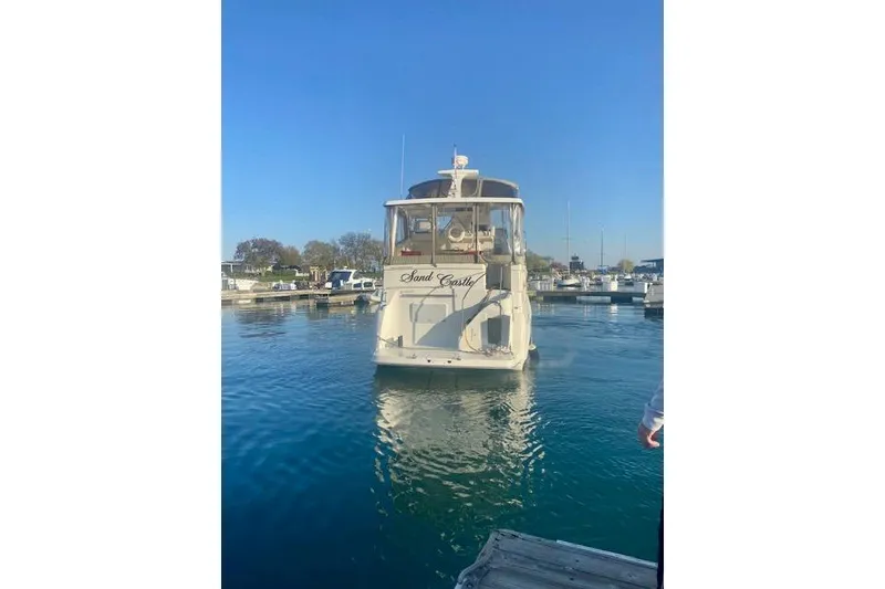 Slide: The Image of 1997 Silverton 352 Motor Yacht docked in a marina under clear blue skies. - 6