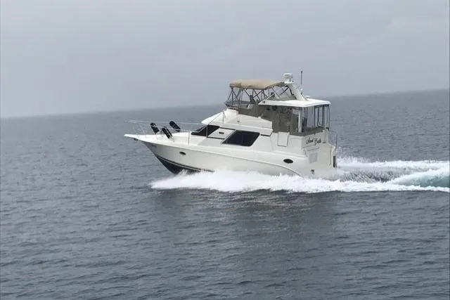 Slide: The Image of 1997 Silverton 352 Motor Yacht cruising on open water. - 7