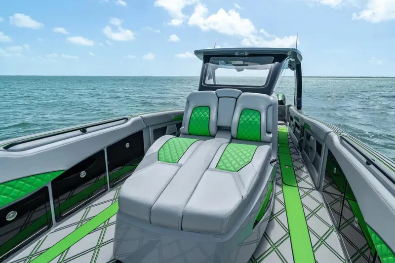 Slide: The Image of Interior of 2026 Deep Impact 399 Sport boat with modern dashboard and green accents. - 10