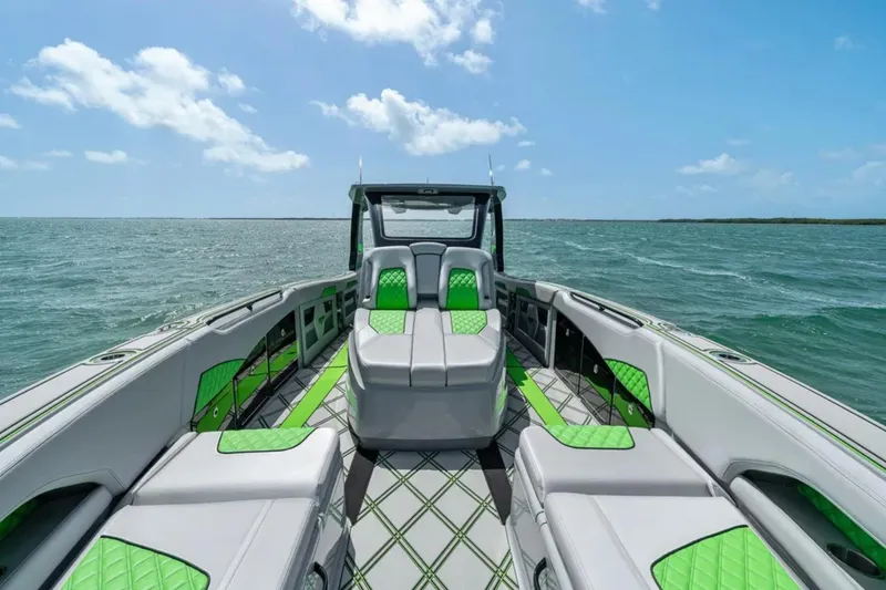 Slide: The Image of Luxury interior of 2026 Deep Impact 399 Sport boat with green and gray seating. - 12