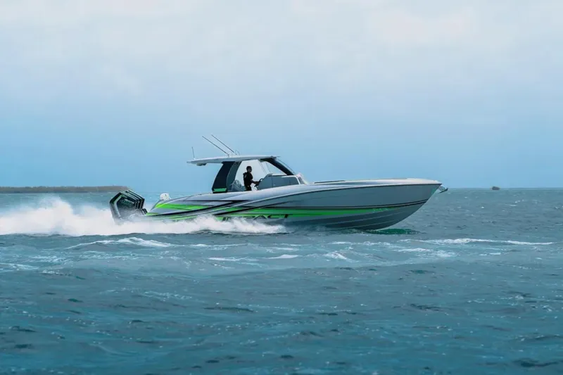 Slide: The Image of 2026 Deep Impact 399 Sport boat cruising on open water, showcasing sleek design and powerful engines. - 2