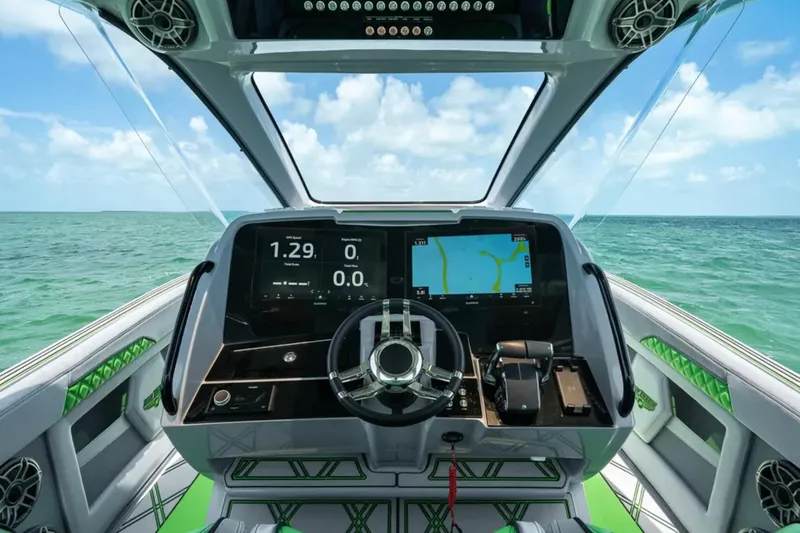 Slide: The Image of 2026 Deep Impact 399 Sport boat on water, featuring sleek design and vibrant green accents. - 24