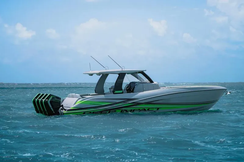 Slide: The Image of 2026 Deep Impact 399 Sport boat with green accents on water. - 5