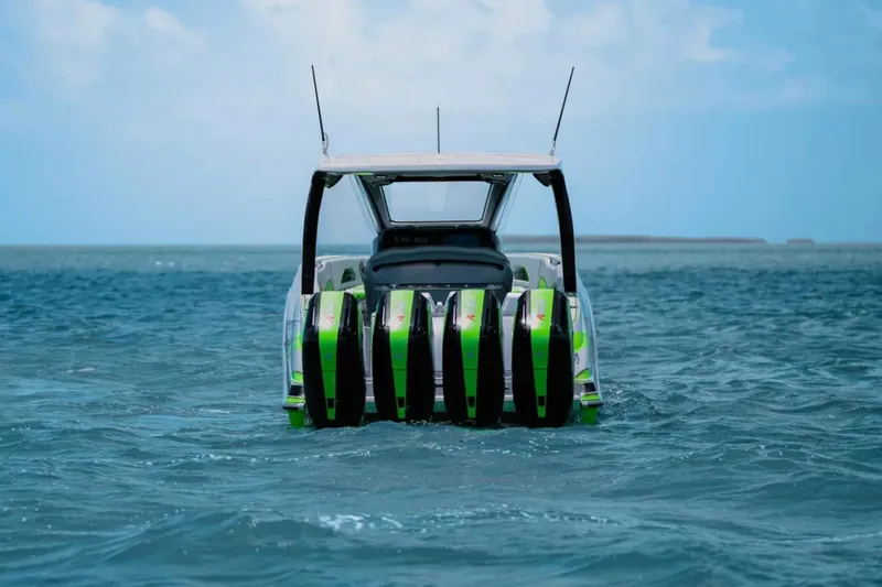 Slide: The Image of Luxury interior of 2026 Deep Impact 399 Sport boat with green accents on open water. - 7