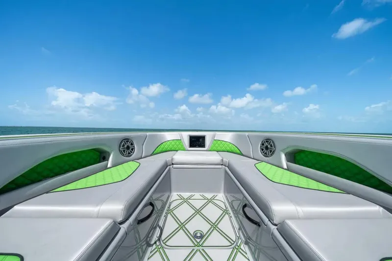 Slide: The Image of Luxurious 2026 Deep Impact 399 Sport boat interior with green accents on a sunny day. - 8
