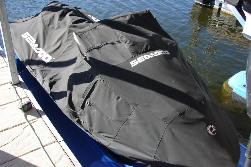 Slide: The Image of 2022 Sea-Doo Wake Pro 230 covered, docked by the water. - 11