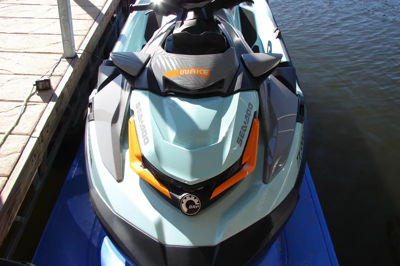 Slide: The Image of 2022 Sea-Doo Wake Pro 230 jet ski docked by the water. - 13