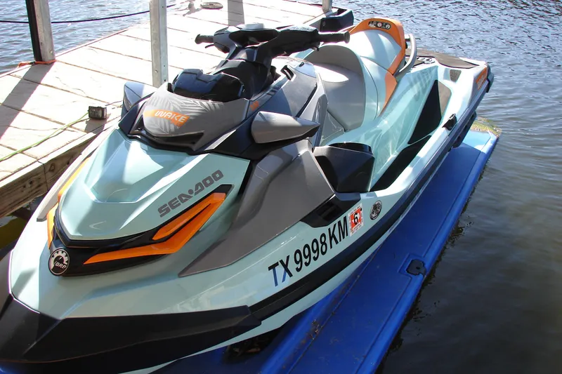 Slide: The Image of 2022 Sea-Doo Wake Pro 230 jet ski docked on water. - 14