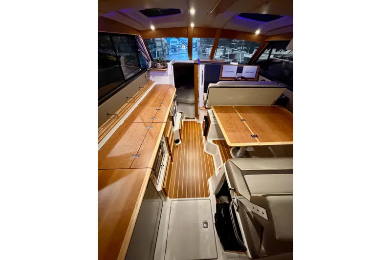 Slide: The Image of 2023 Cutwater C-30 Sedan interior with wood finishes and modern navigation equipment. - 5